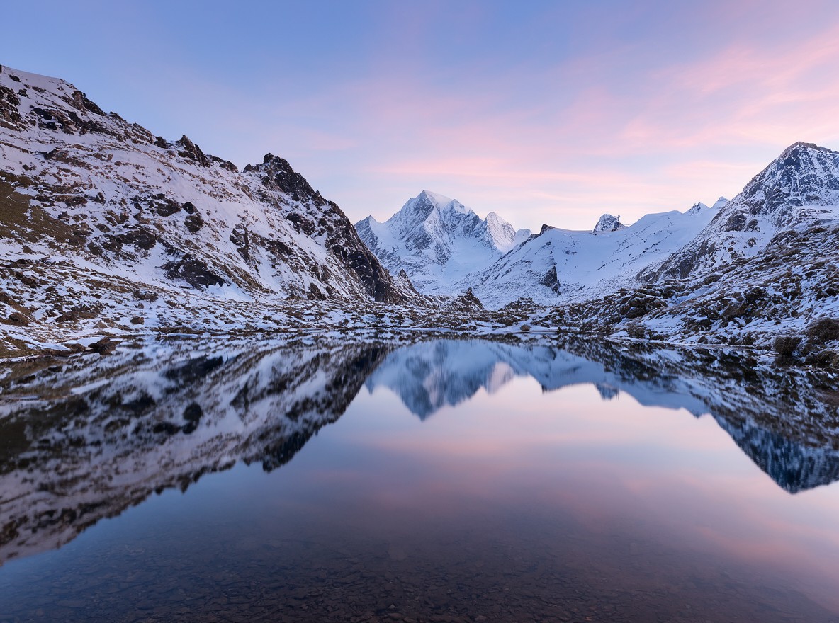 Montañas reflejadas en un lago al amanecer